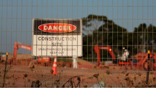 Danger Warning Sign on a Fence Outside a Construction Project